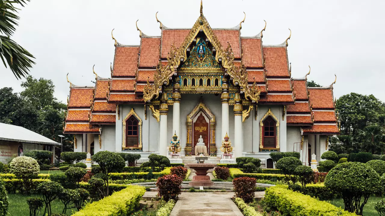 Thai Monastery in Bodh Gaya with bronze Buddha statue and traditional Thai-style architecture